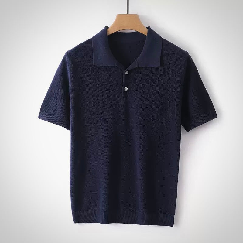 Navy blue polo shirt on a wooden hanger against a white background