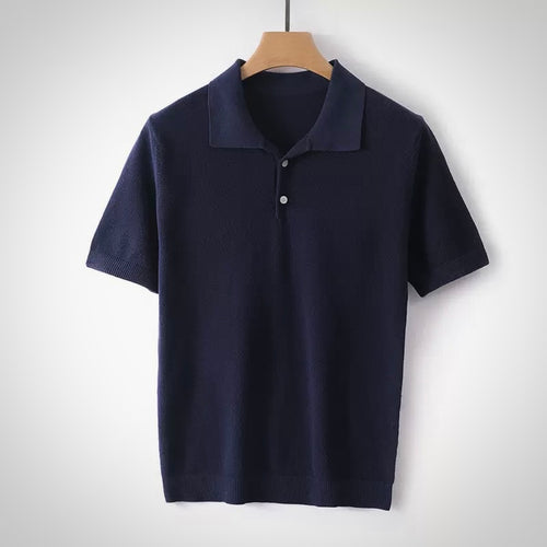 Navy blue polo shirt on a wooden hanger against a white background