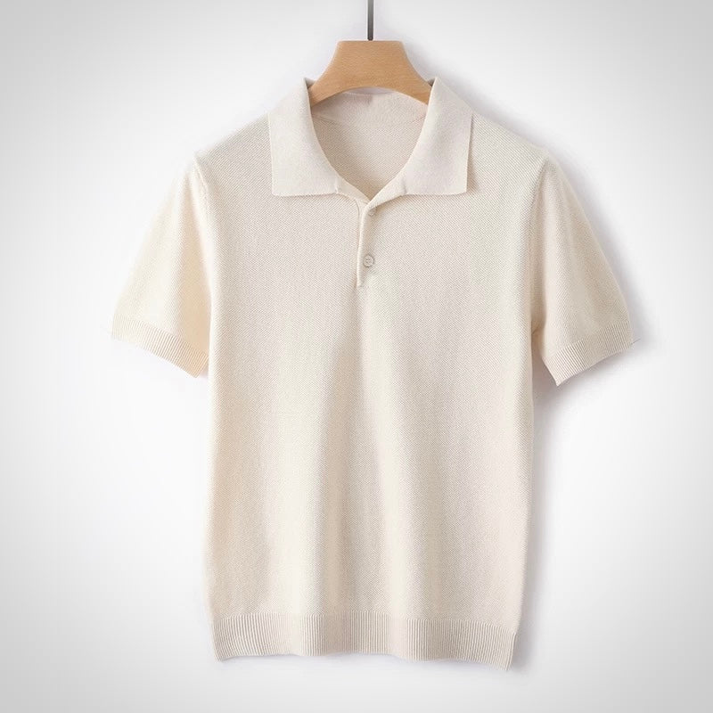 Beige short-sleeve knit polo shirt on a wooden hanger against a white background